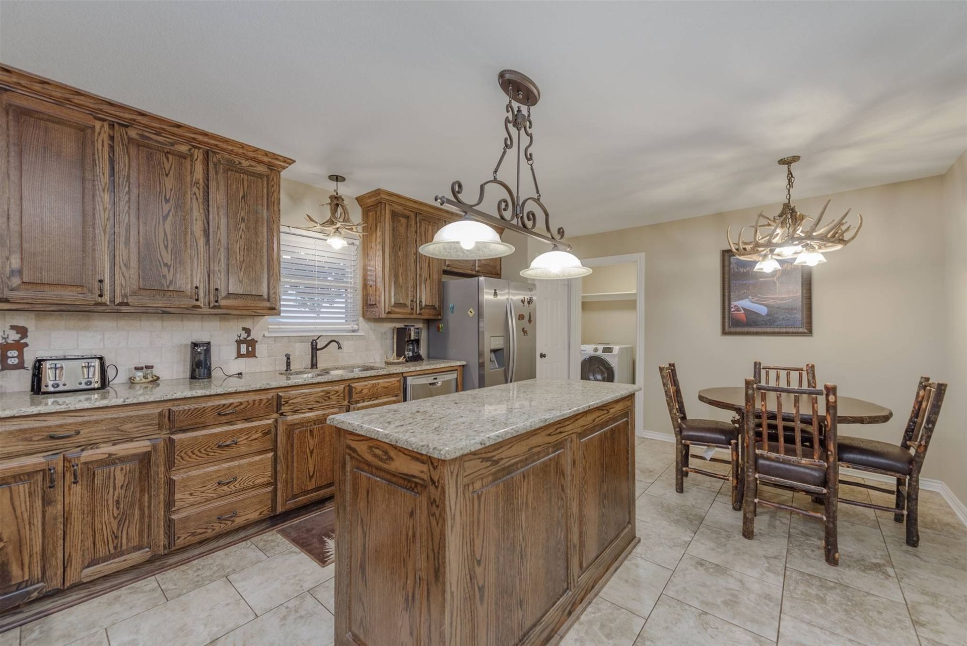 A kitchen with a large island and a dining table