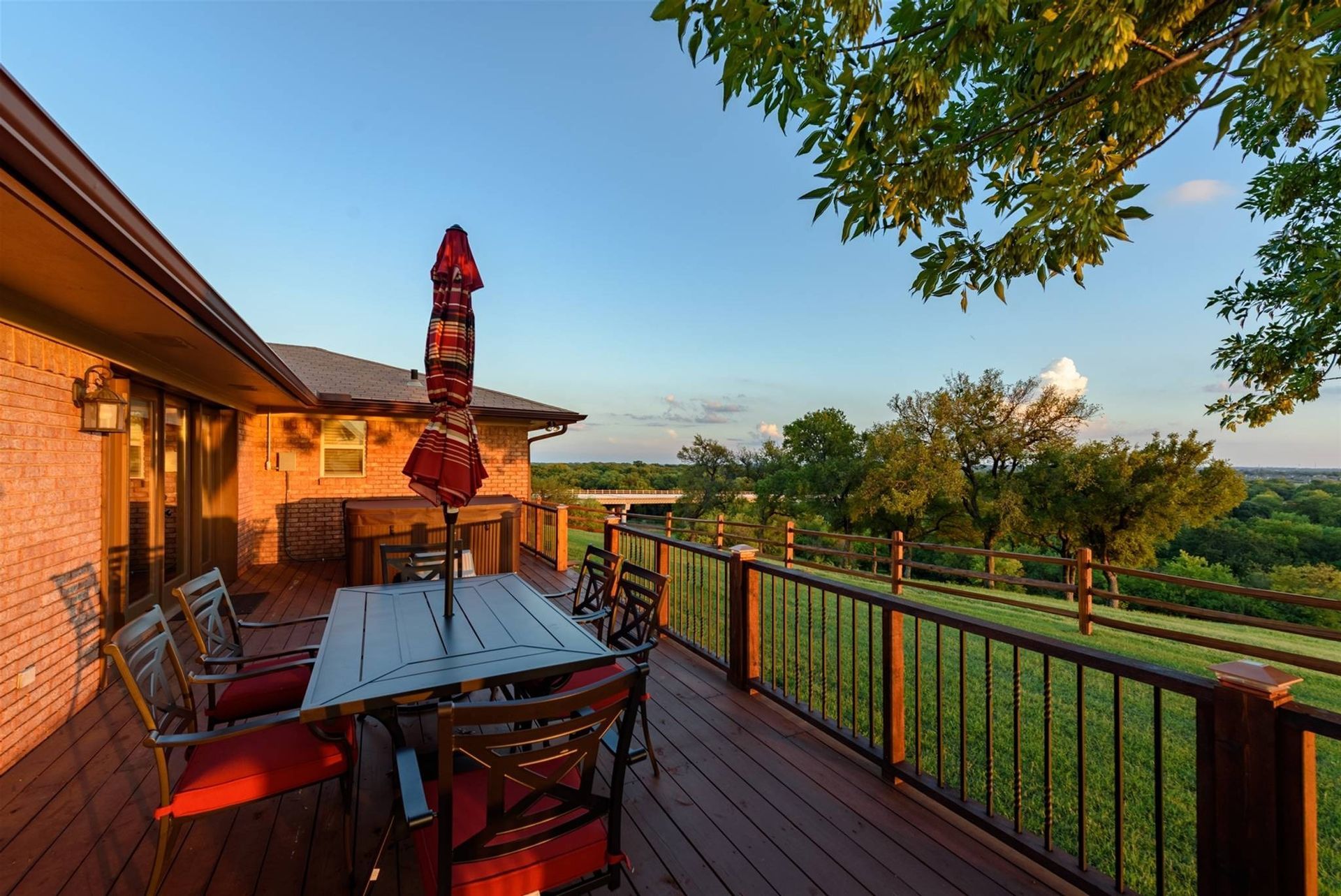 A deck with a table and chairs and an umbrella