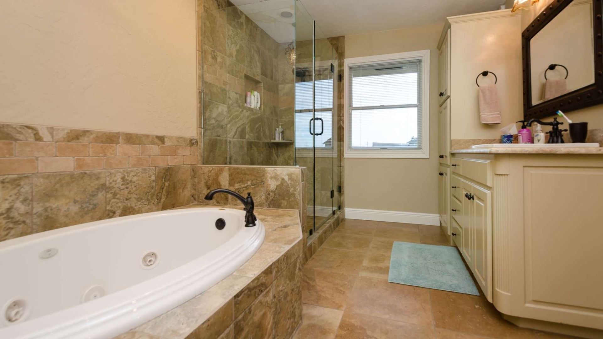 A bathroom with a jacuzzi tub and a walk in shower.