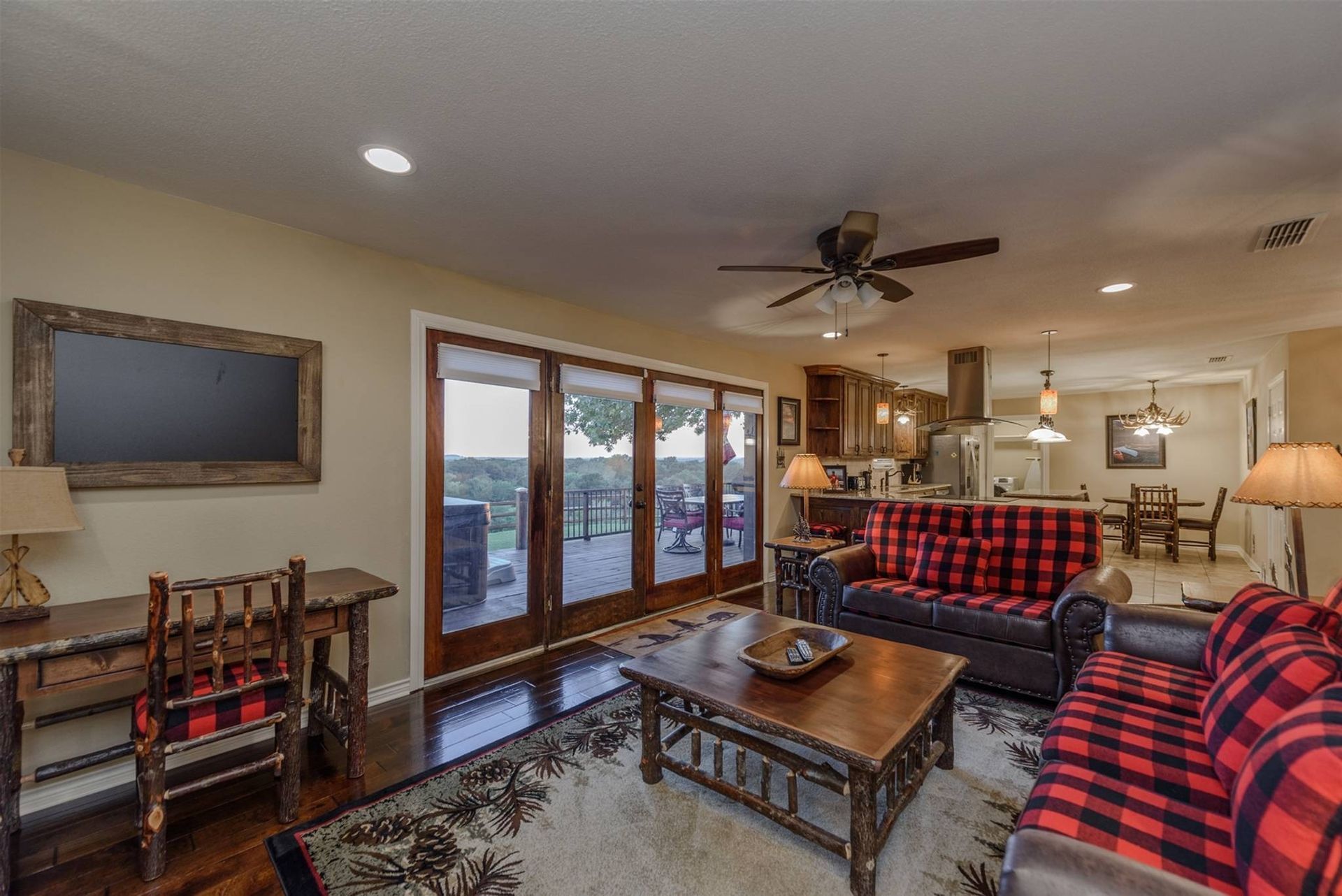 A living room filled with furniture and a ceiling fan.