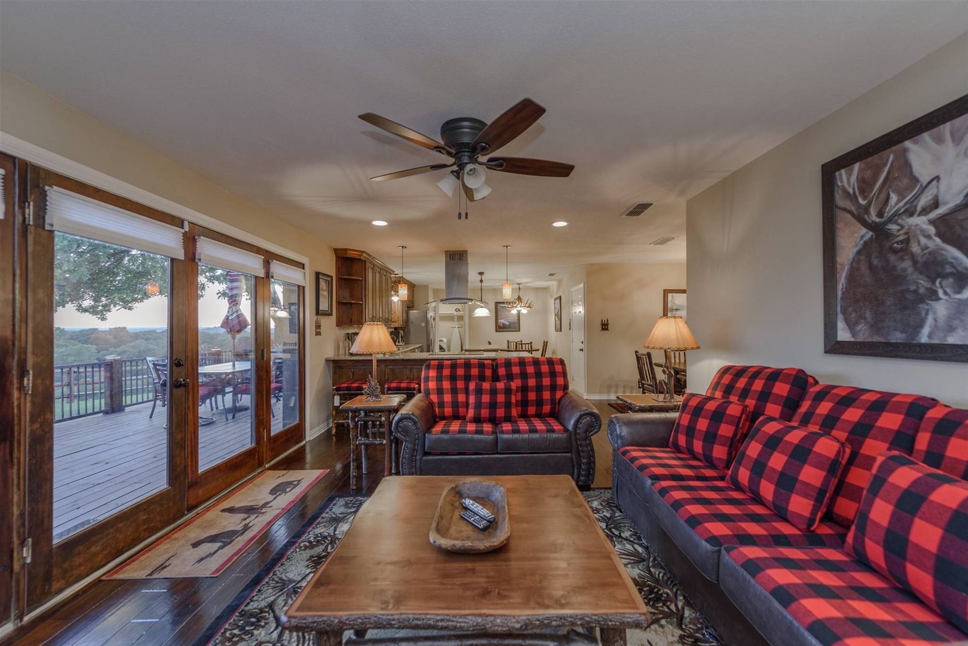 A living room with two couches , a coffee table , and a ceiling fan.