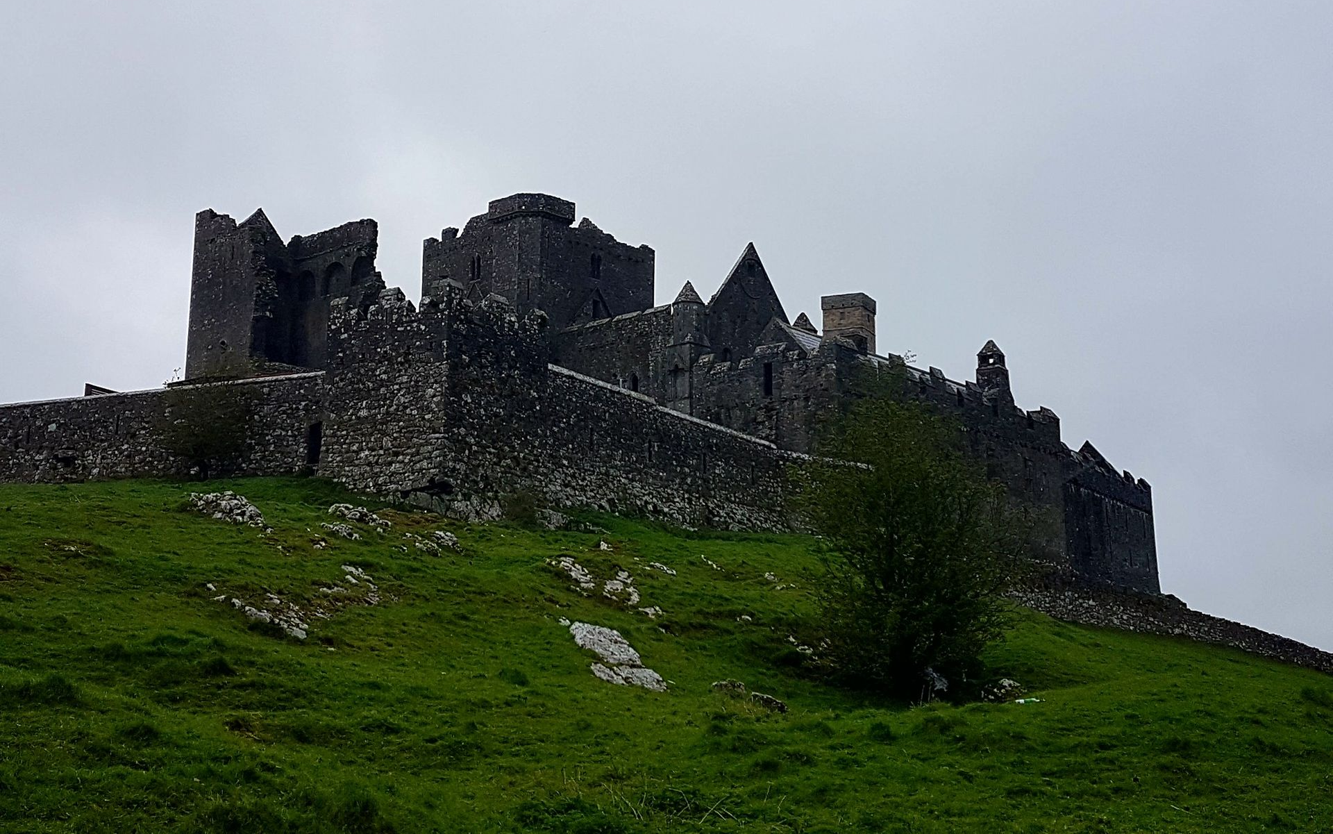 Ross Castle emerging from morning mist over Lough Leane in Killarney, Ireland, legendary home of banshee folklore
