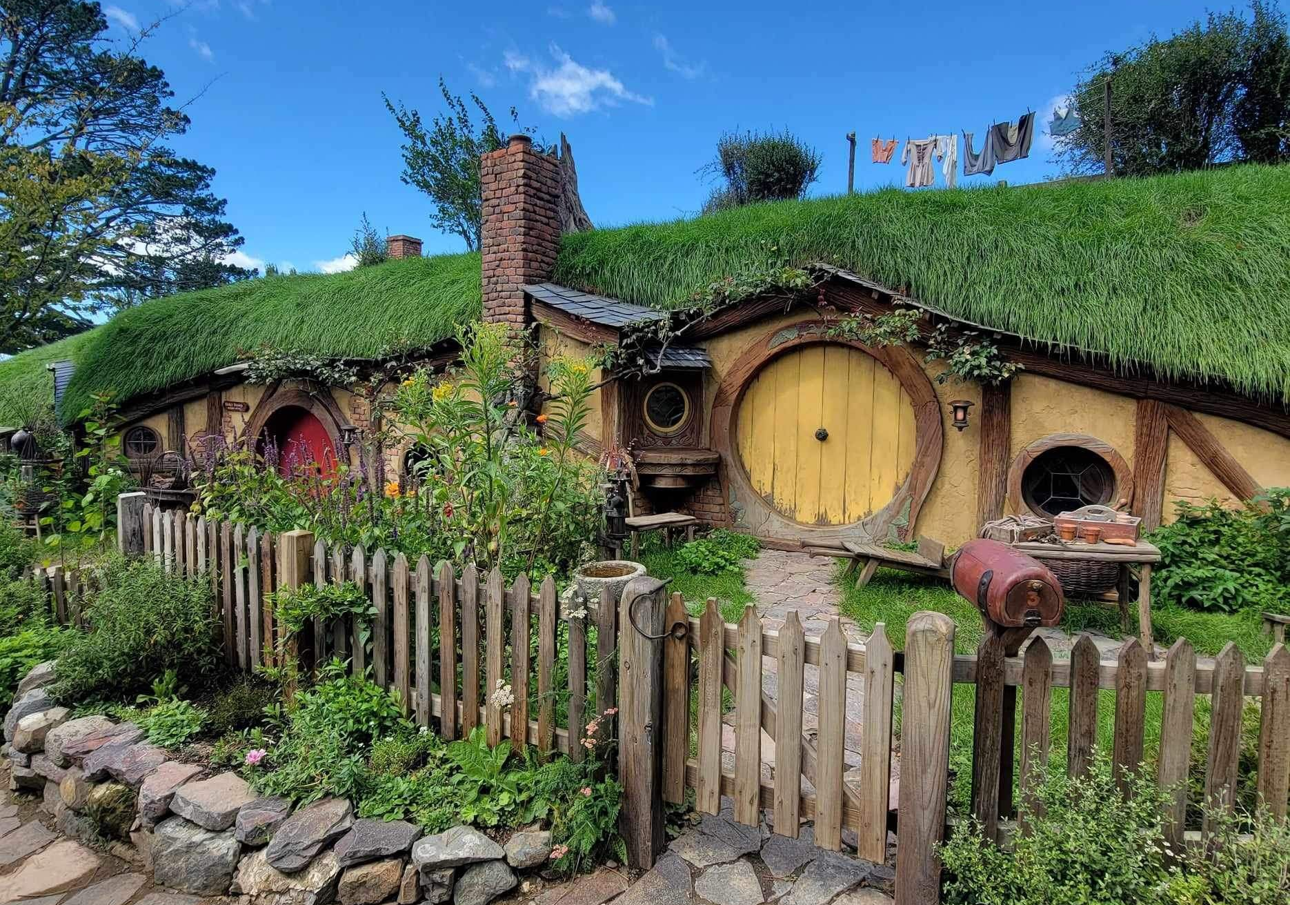 Hobbit hole with round door, green roof in New Zealand