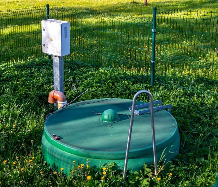 Green Septic Tank Lid Surrounded by Grass With a Metal Handle — All Class Liquid Waste in Crows Nest, QLD 