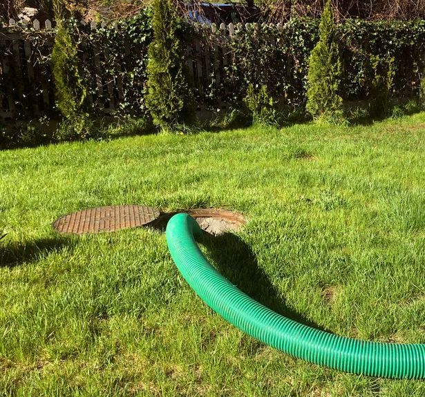 A Green Hose Extends From an Open Septic Tank — All Class Liquid Waste in Pittsworth, QLD