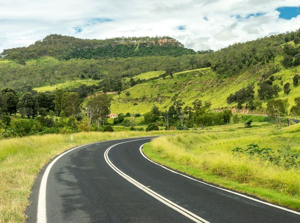 Winding Road Through Lush Green Hills and Fields — All Class Liquid Waste in Gatton, QLD