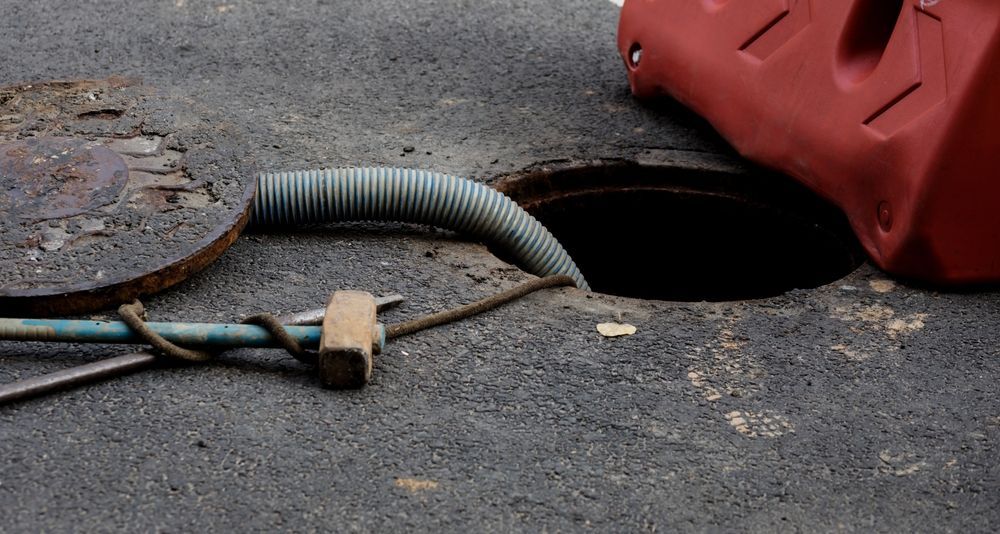 Open Manhole With a Flexible Hose — All Class Liquid Waste in Westbrook, QLD
