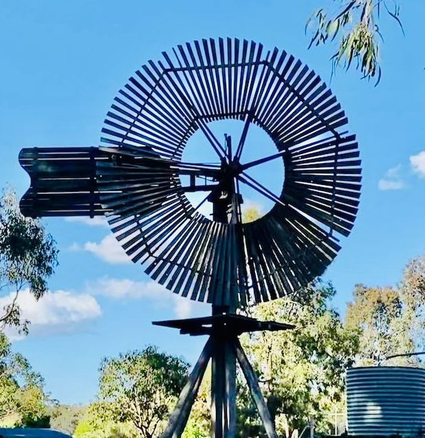 A Weathered Windmill Against a Blue Sky — All Class Liquid Waste in Highfields, QLD