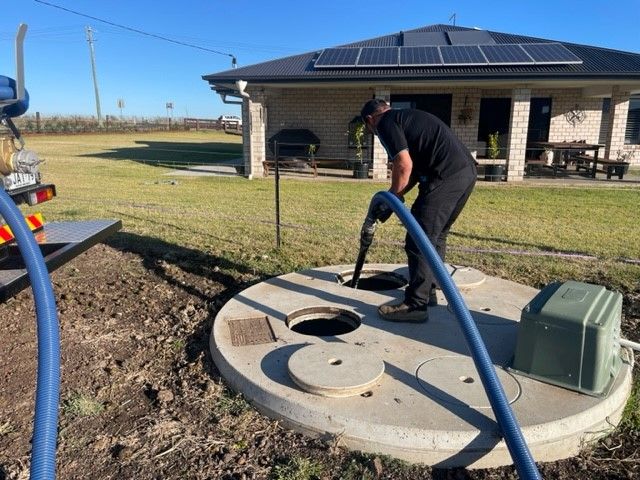 Man Pulling the Hose — Professional Septic Tank Cleaning in the Toowoomba Region, QLD
