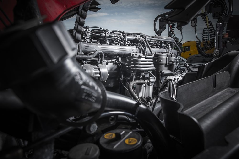 A close-up of a vehicle engine, with various components and hoses — Cadillac Transport Repairs in Winnellie, NT