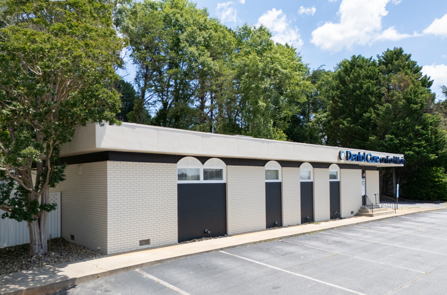 A white building with a blue awning and the word davita on it