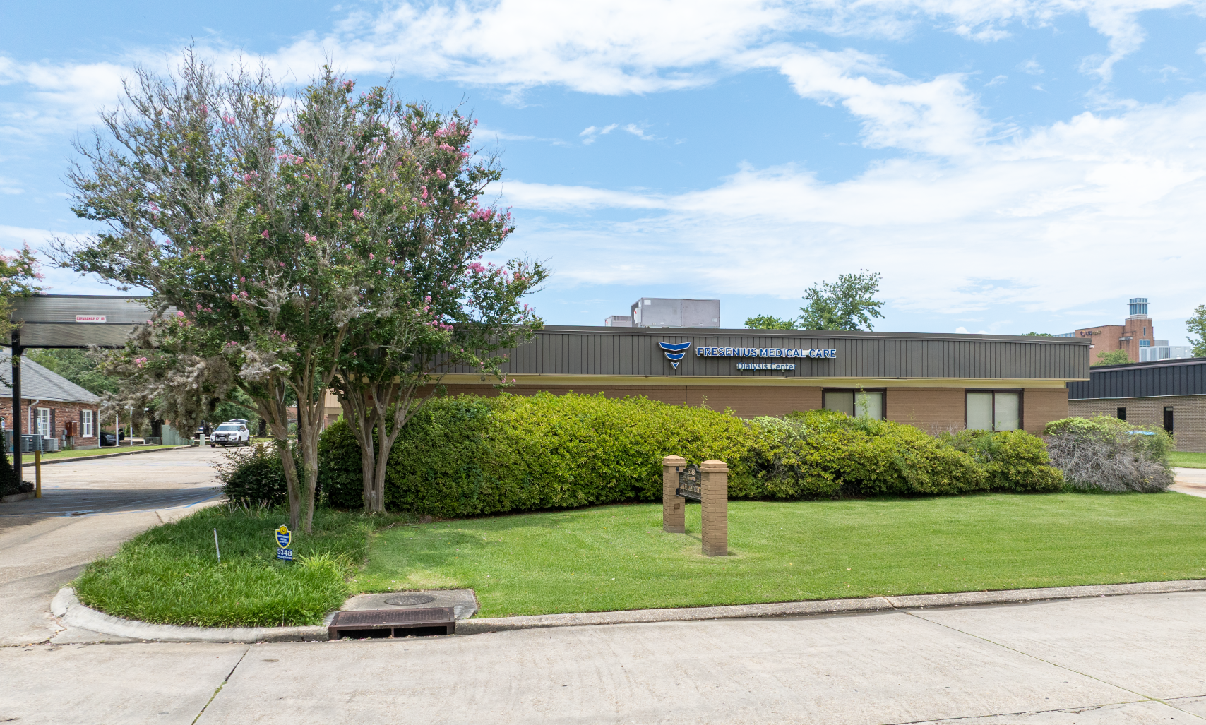 A white building with a blue awning and the word davita on it