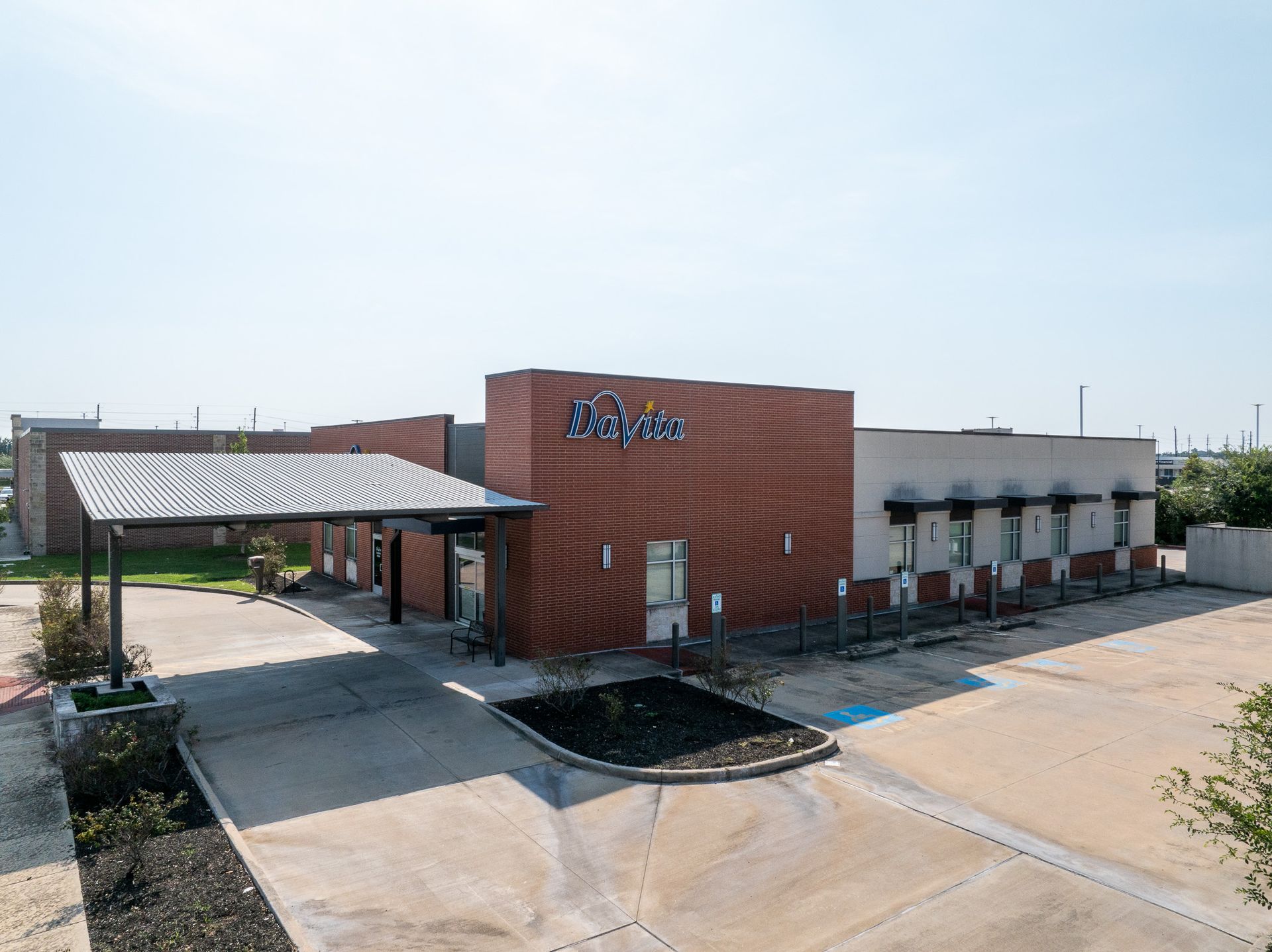 A white building with a blue awning and the word davita on it