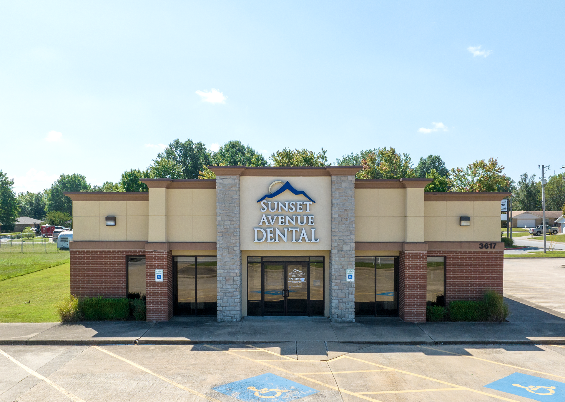 A white building with a blue awning and the word davita on it