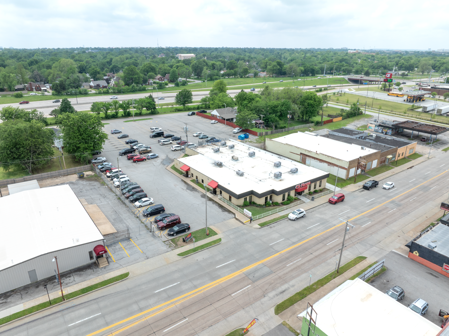 An aerial view of a CSL Plasma with a lot of nearby buildings and parking lots.