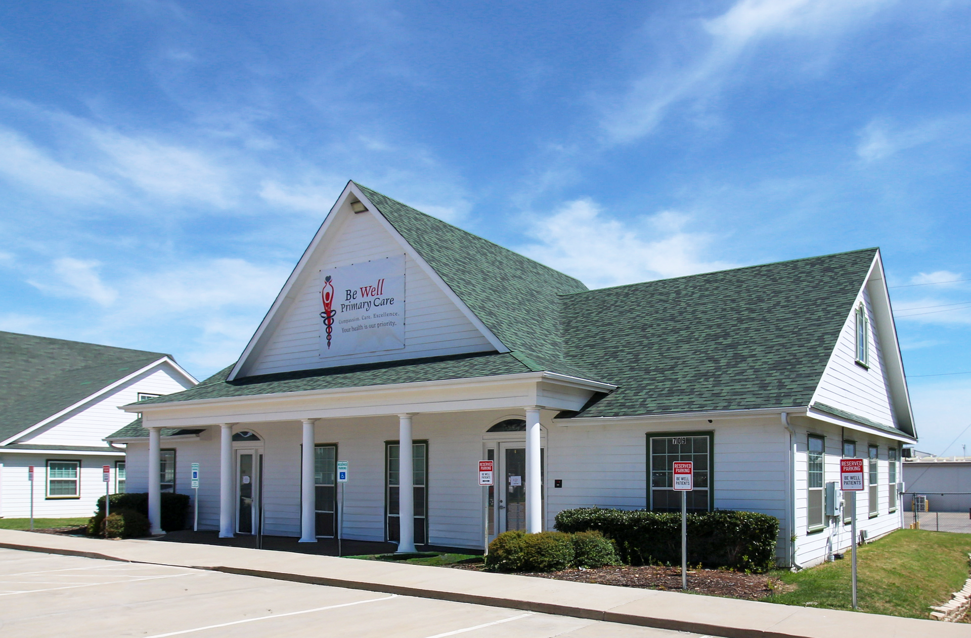 A white building with a blue awning and the word davita on it