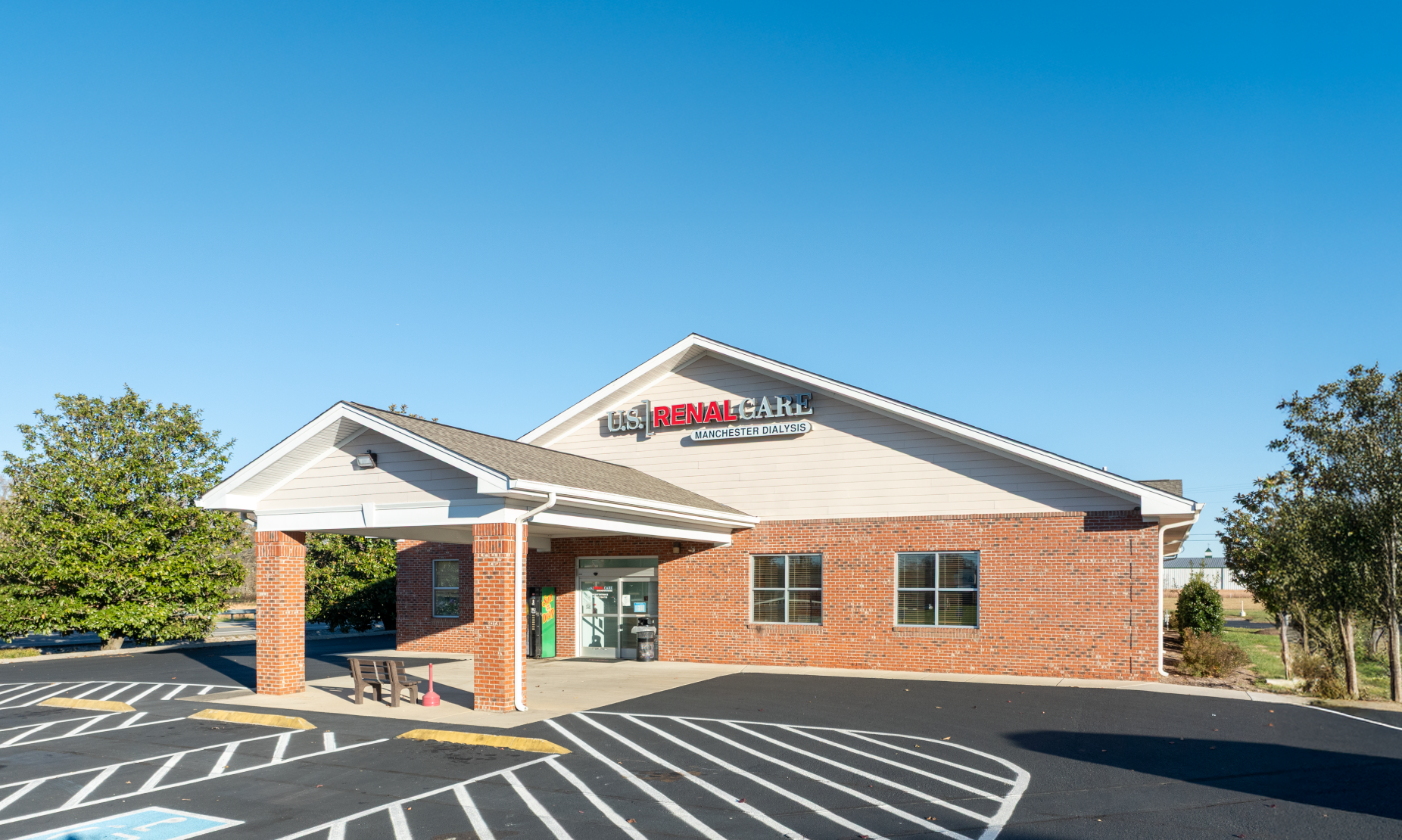 A white building with a blue awning and the word davita on it
