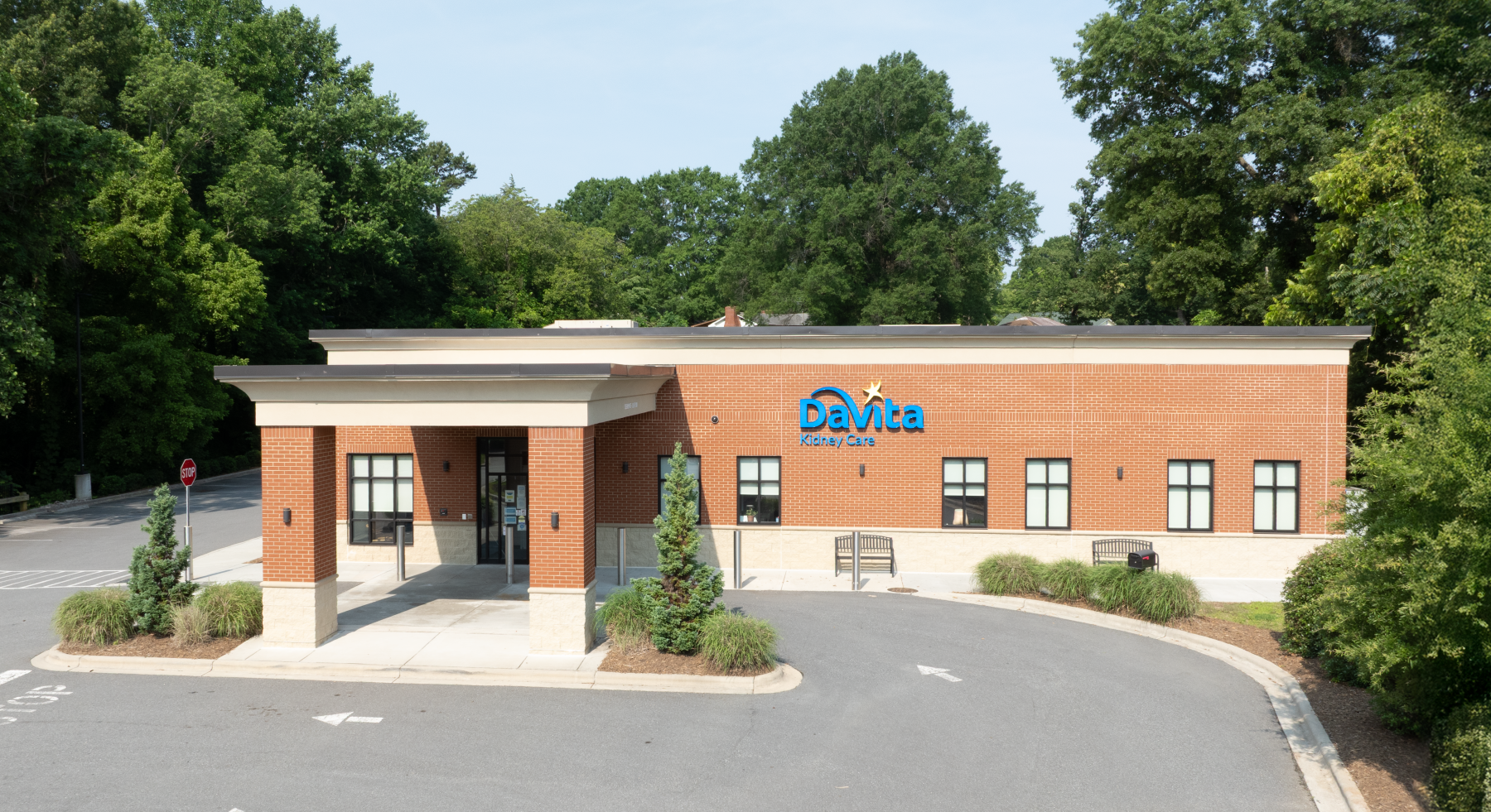 A white building with a blue awning and the word davita on it