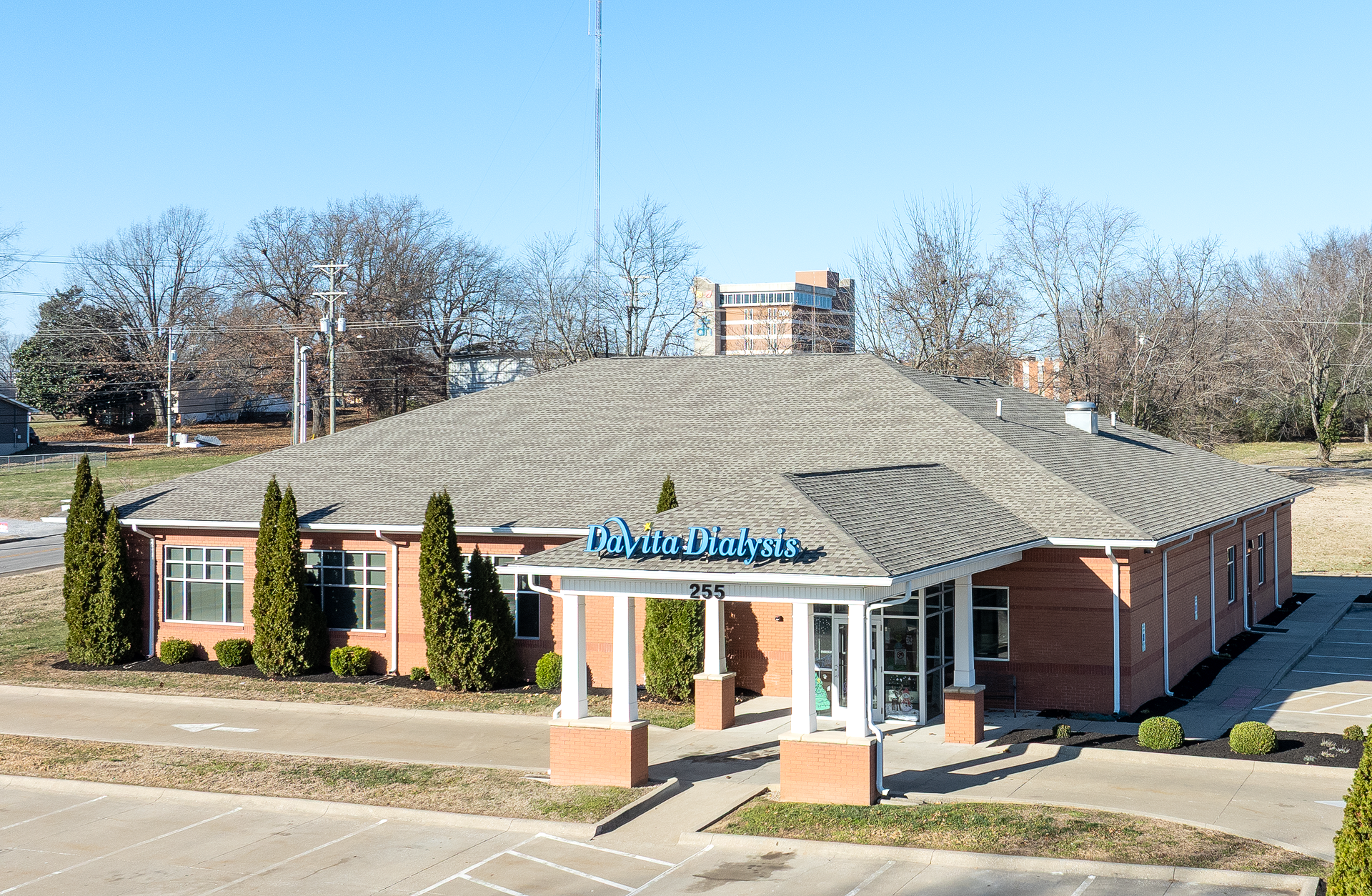 A white building with a blue awning and the word davita on it