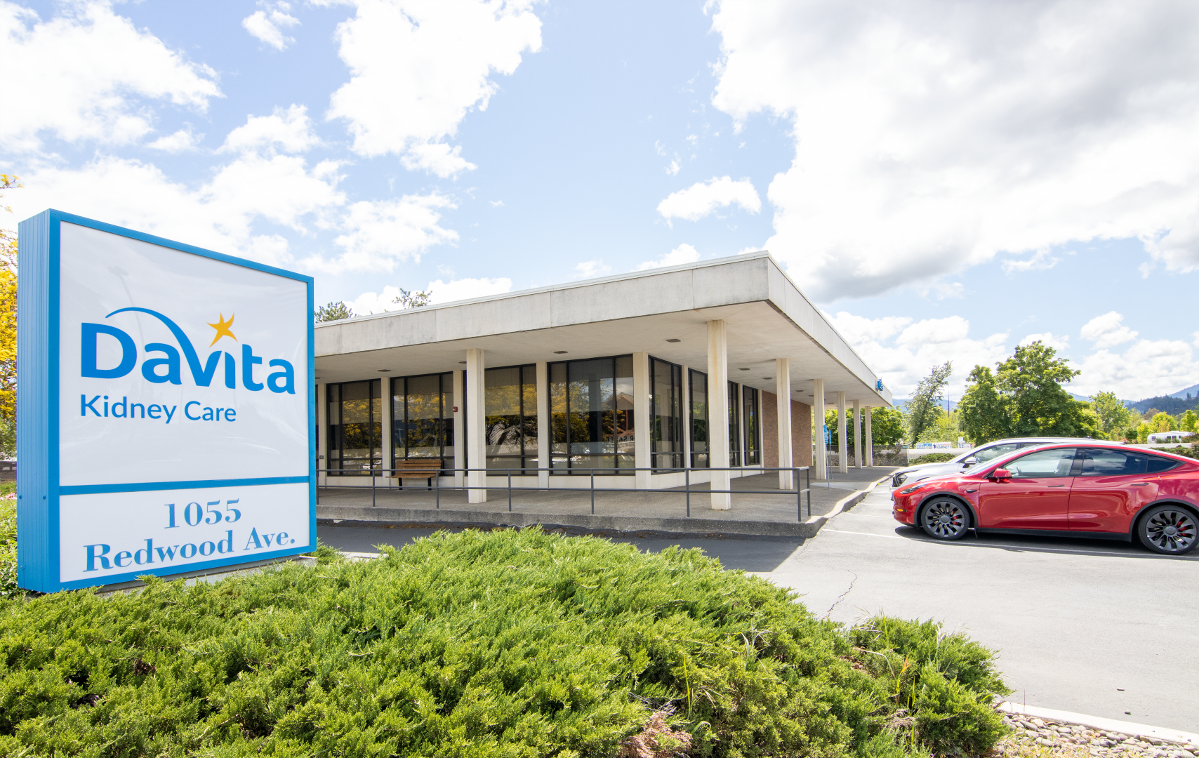 A white building with a blue awning and the word davita on it