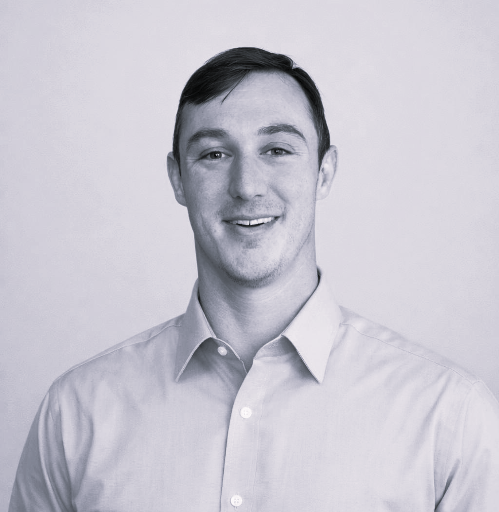 Harrison Warr smiles at the camera against a plain background.