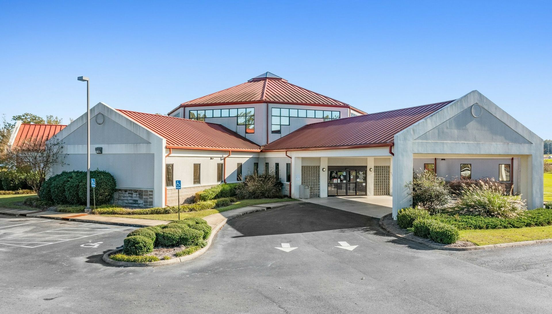 A white building with a blue awning and the word davita on it