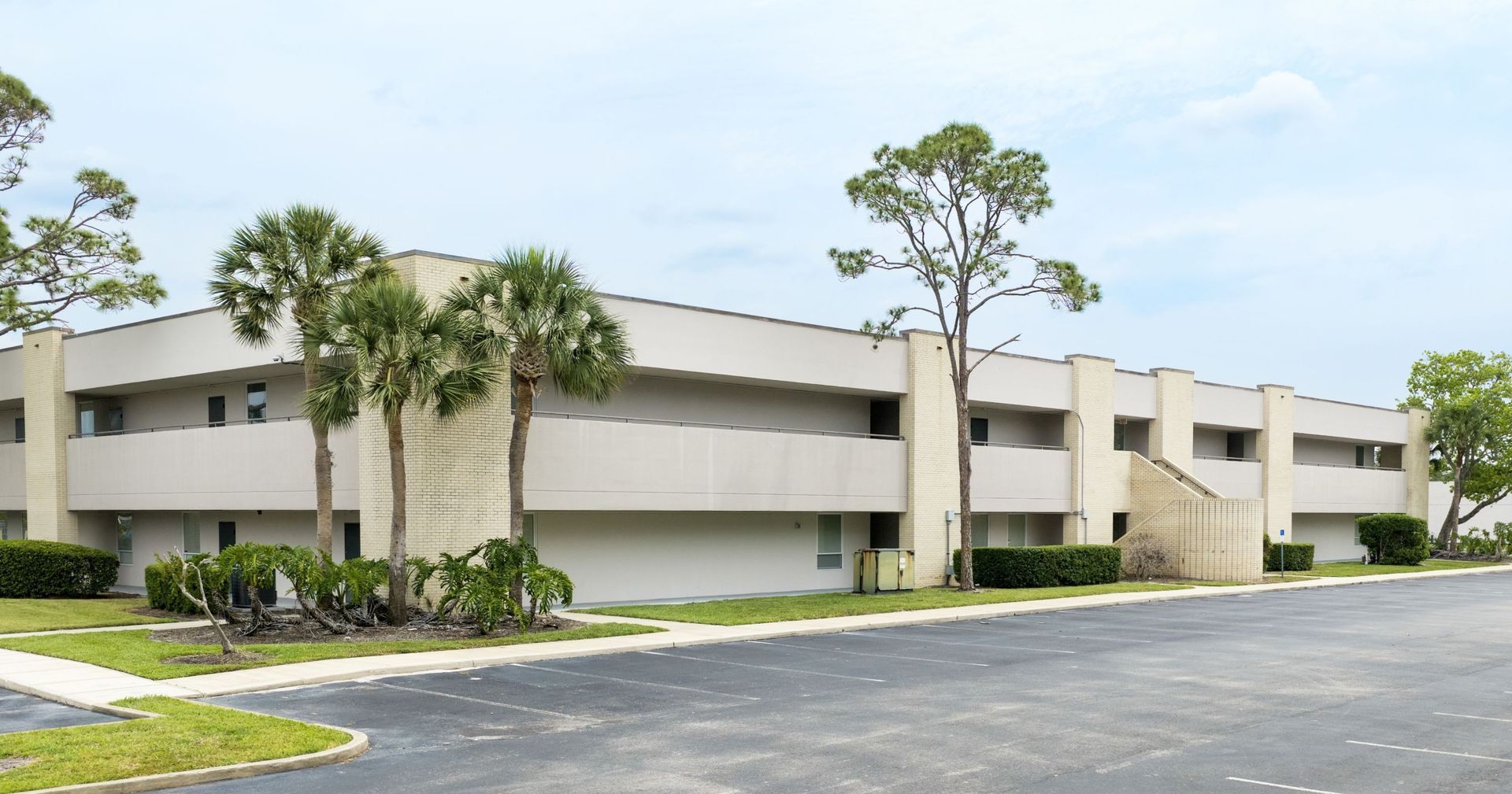 Pediatric Associates clinic condos in Sanford, FL with palm trees and a paved parking lot under a clear sky