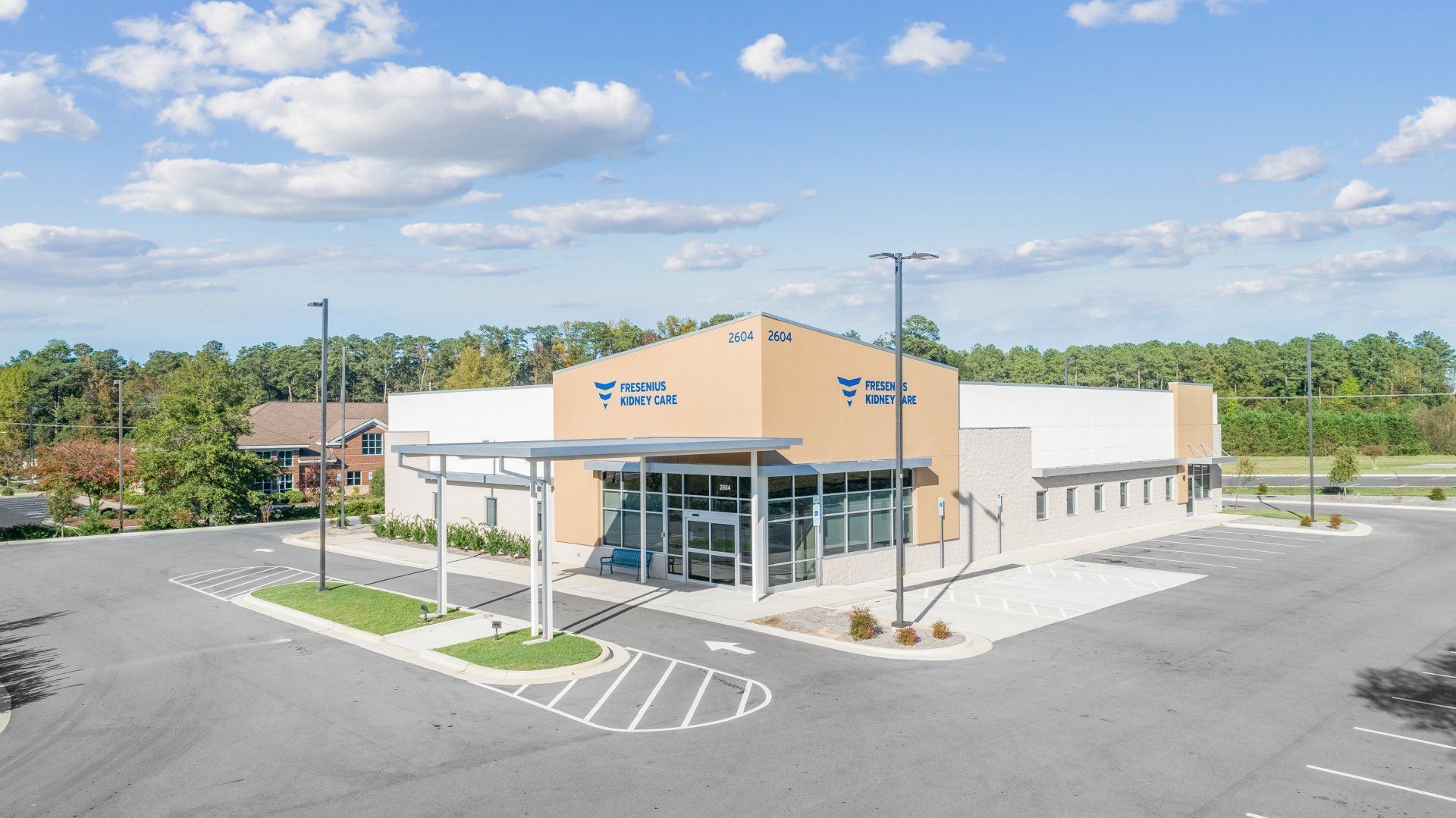 An aerial view of a store with a parking lot in front of it.