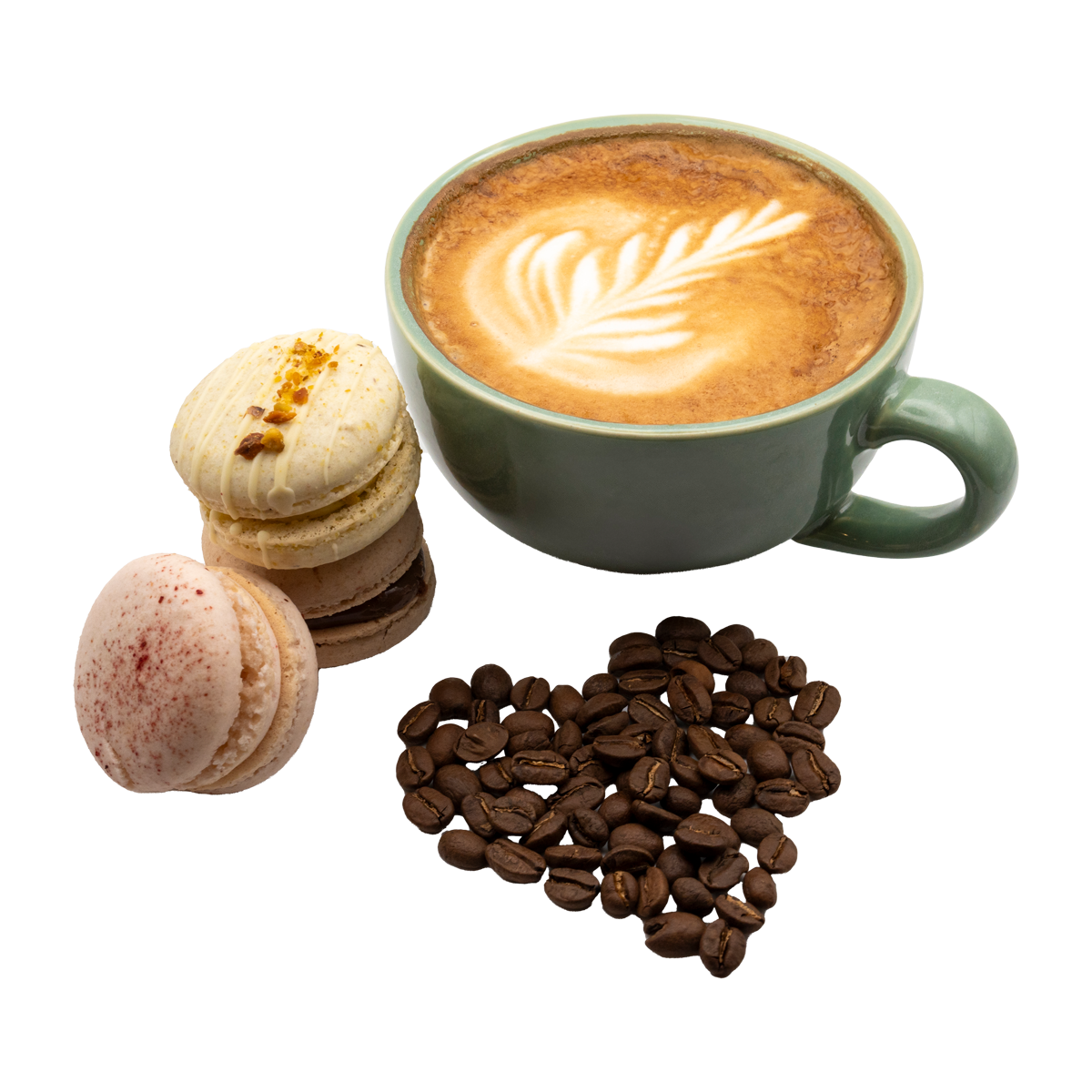 A cup of cappuccino next to a heart of coffee beans and macarons