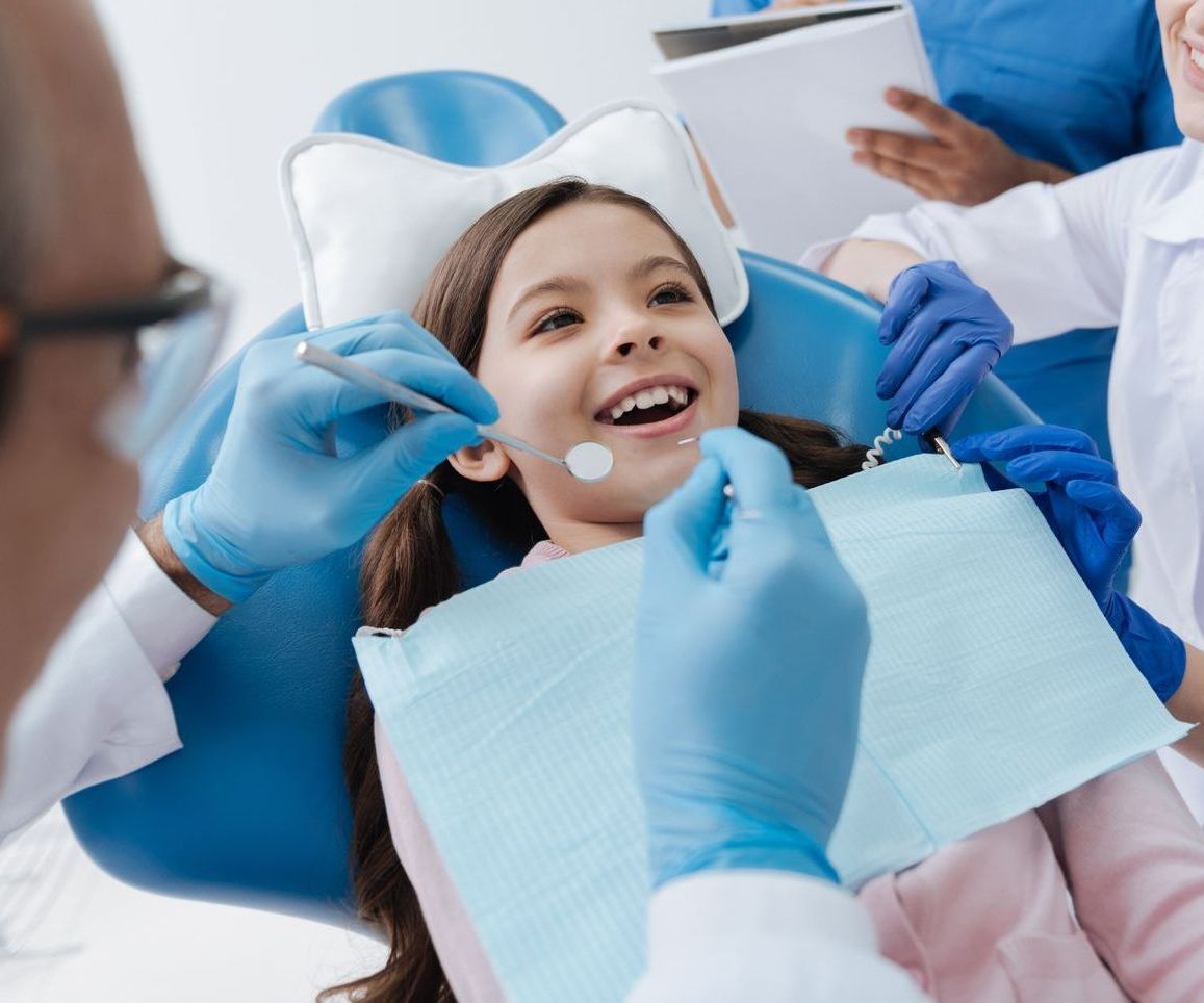Smiling young patient getting her first dental treatment