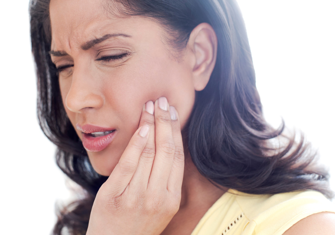 Photo of woman holding painful jaw
