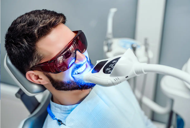 man in dental chair getting teeth whitening