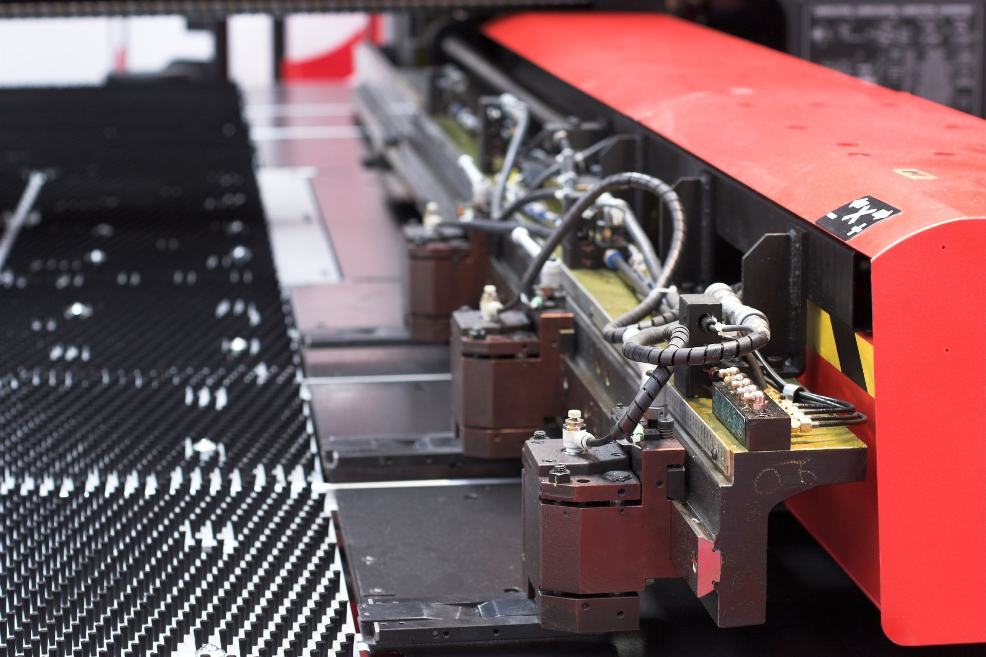 A red and black machine with a lot of wires coming out of it