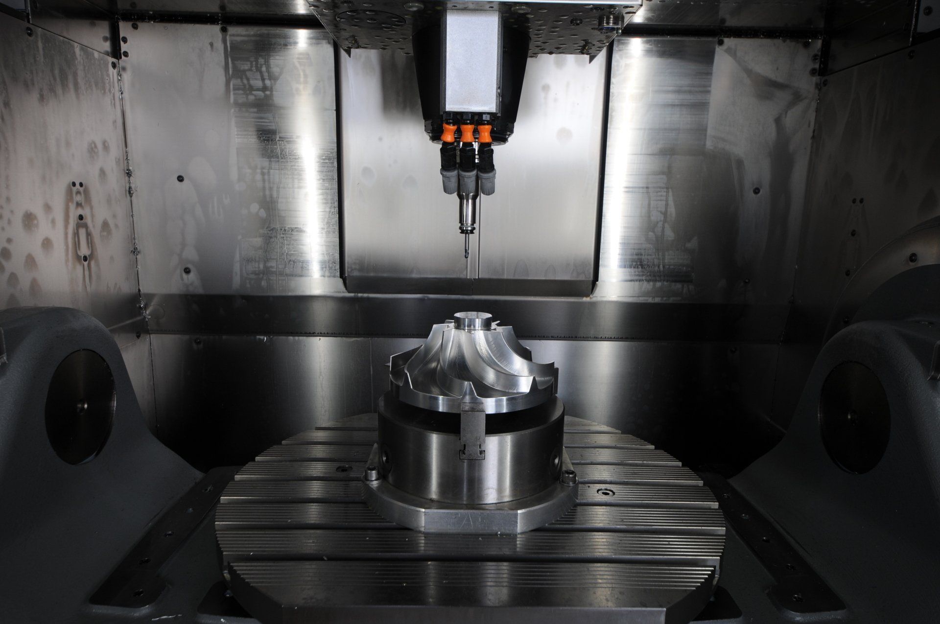 A machine is cutting a piece of metal on a table