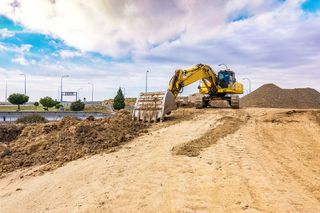Driveway Paving — Excavator In Soil Pathway in Fresno, CA