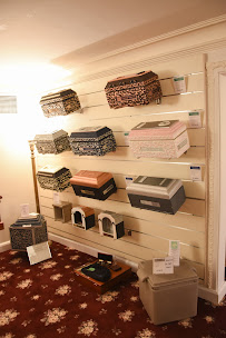 There are many different types of urns on display on the wall.