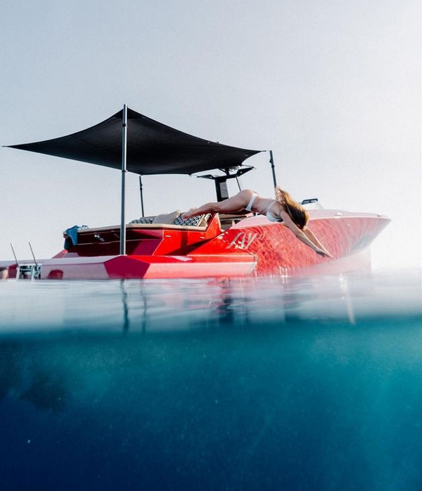Luxury yacht anchored in the Mediterranean with underwater view of the red hull