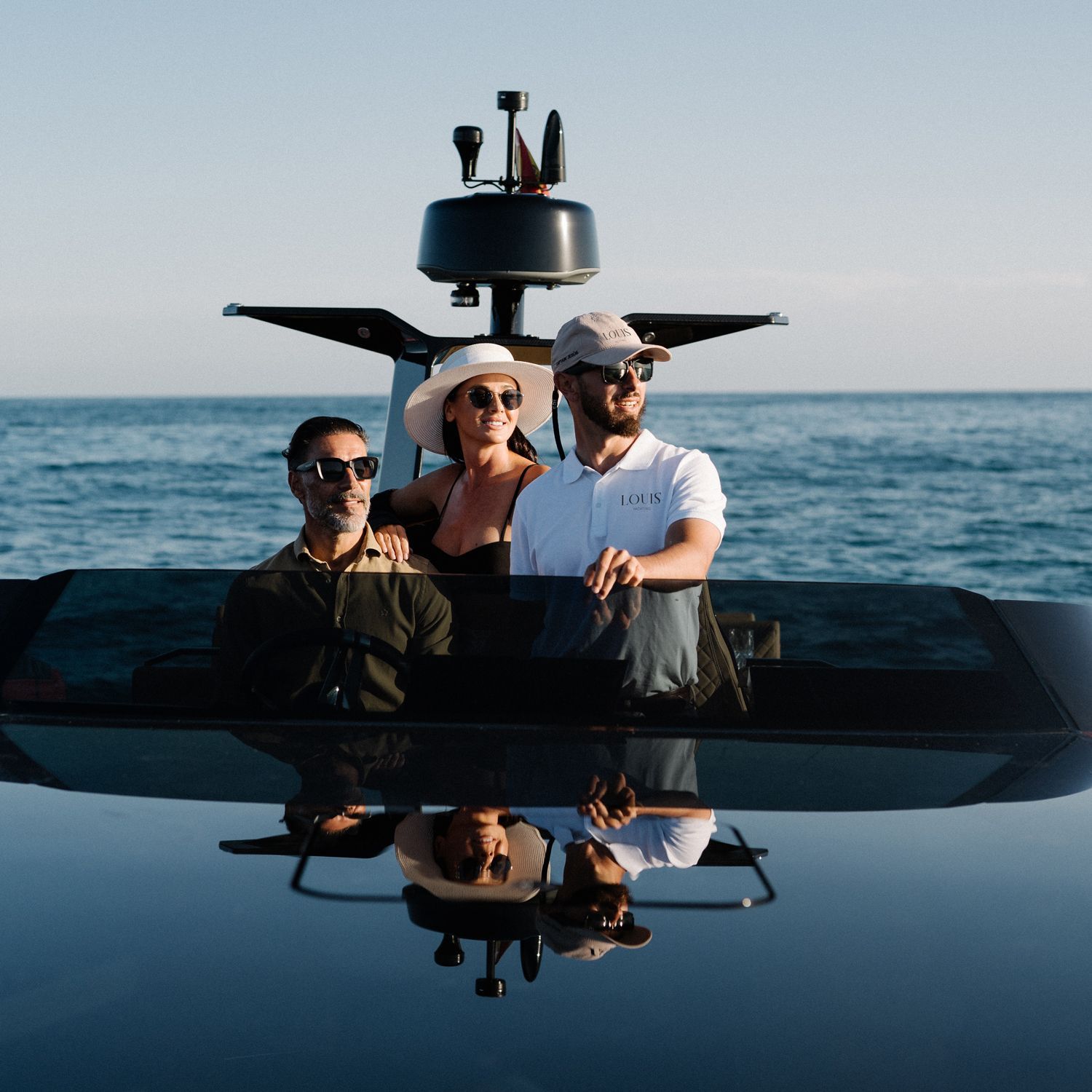 Top-down drone shot of a red Louis Yachting yacht with guests onboard