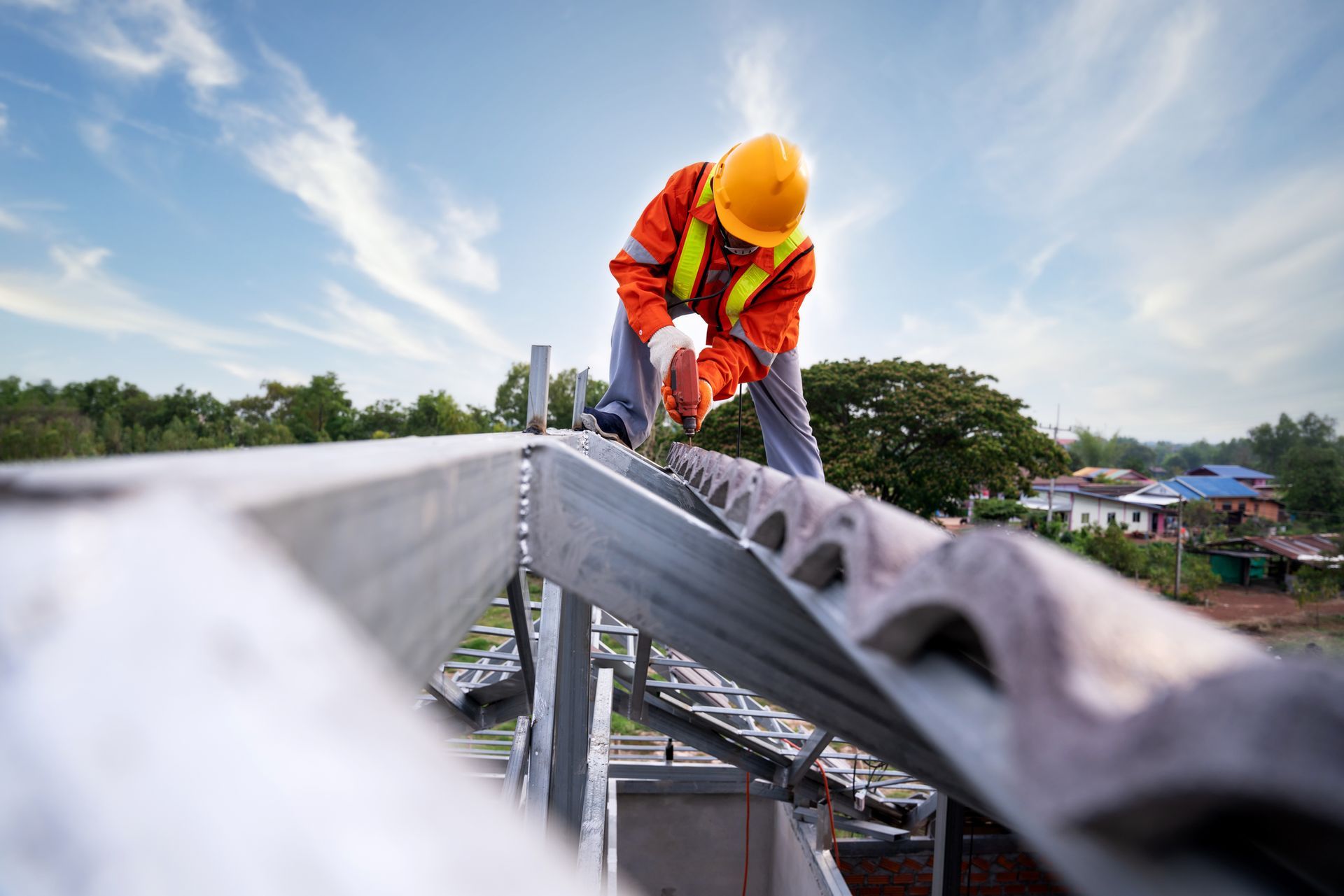 A commercial roofing contractor using a drill to install a roof, showcasing expert roofing services.