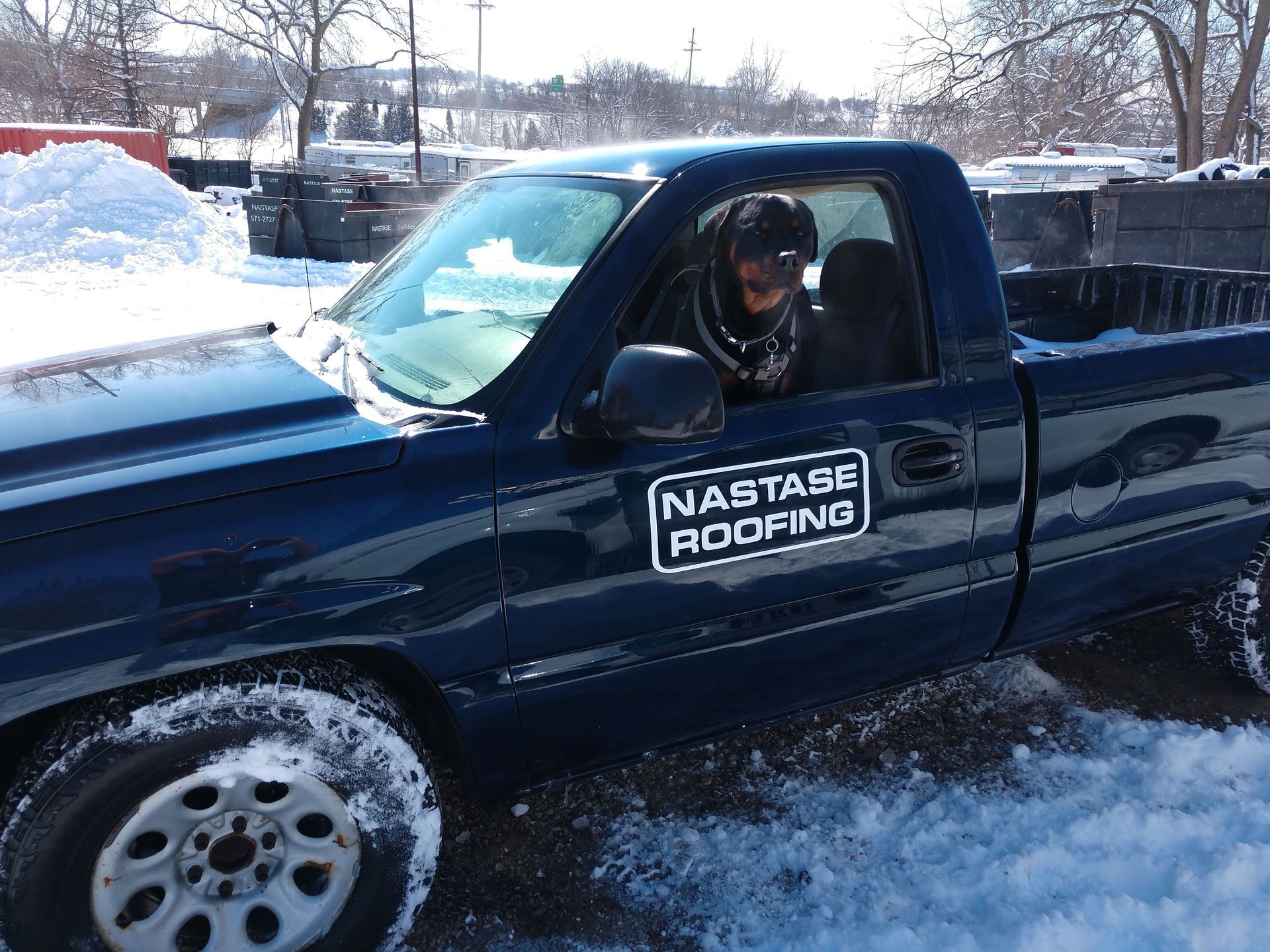 A dark blue pickup truck parked in the snow, featuring a 