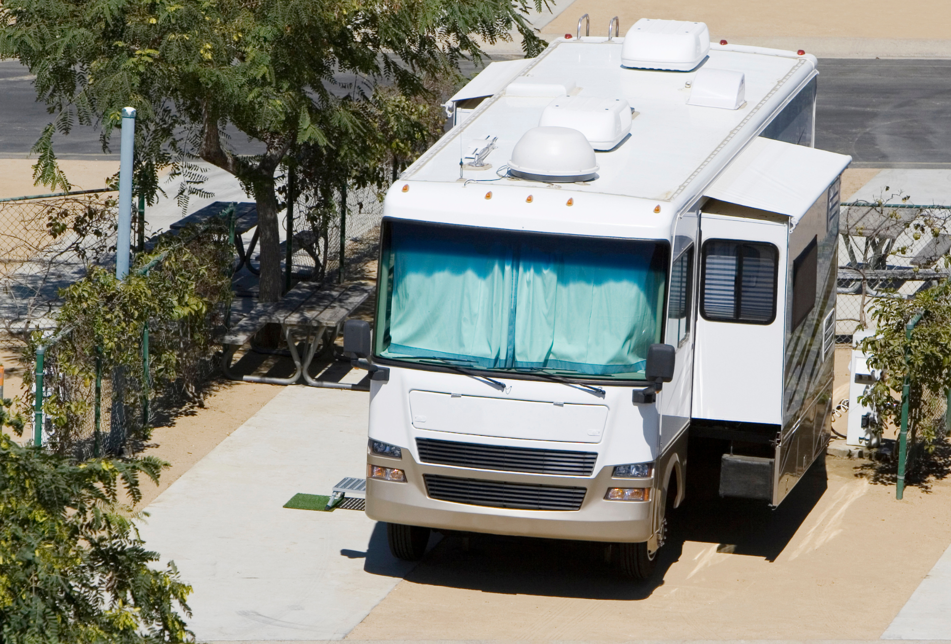 A large white rv is parked in a parking lot