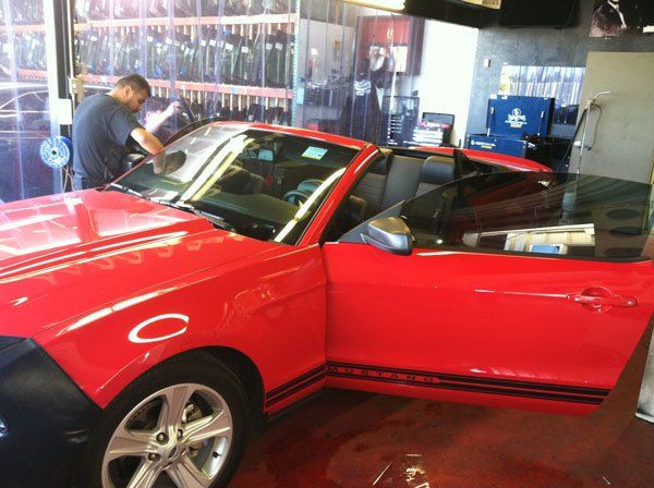 Red Car On Repair — San Bernardino, CA — Best Price Auto Glass