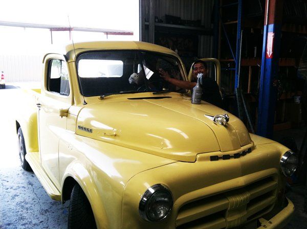Yellow Car And A Man Cleaning — San Bernardino, CA — Best Price Auto Glass