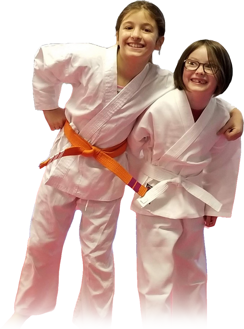 two young girls in karate uniforms are posing for a picture .