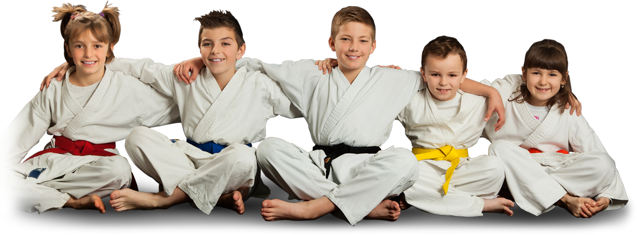 a group of children in karate uniforms are sitting on the floor with their arms around each other .
