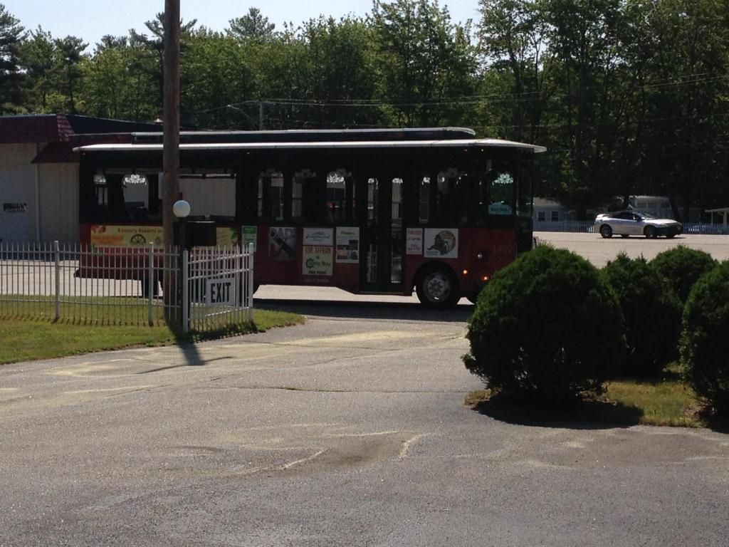 A red bus is parked in a parking lot