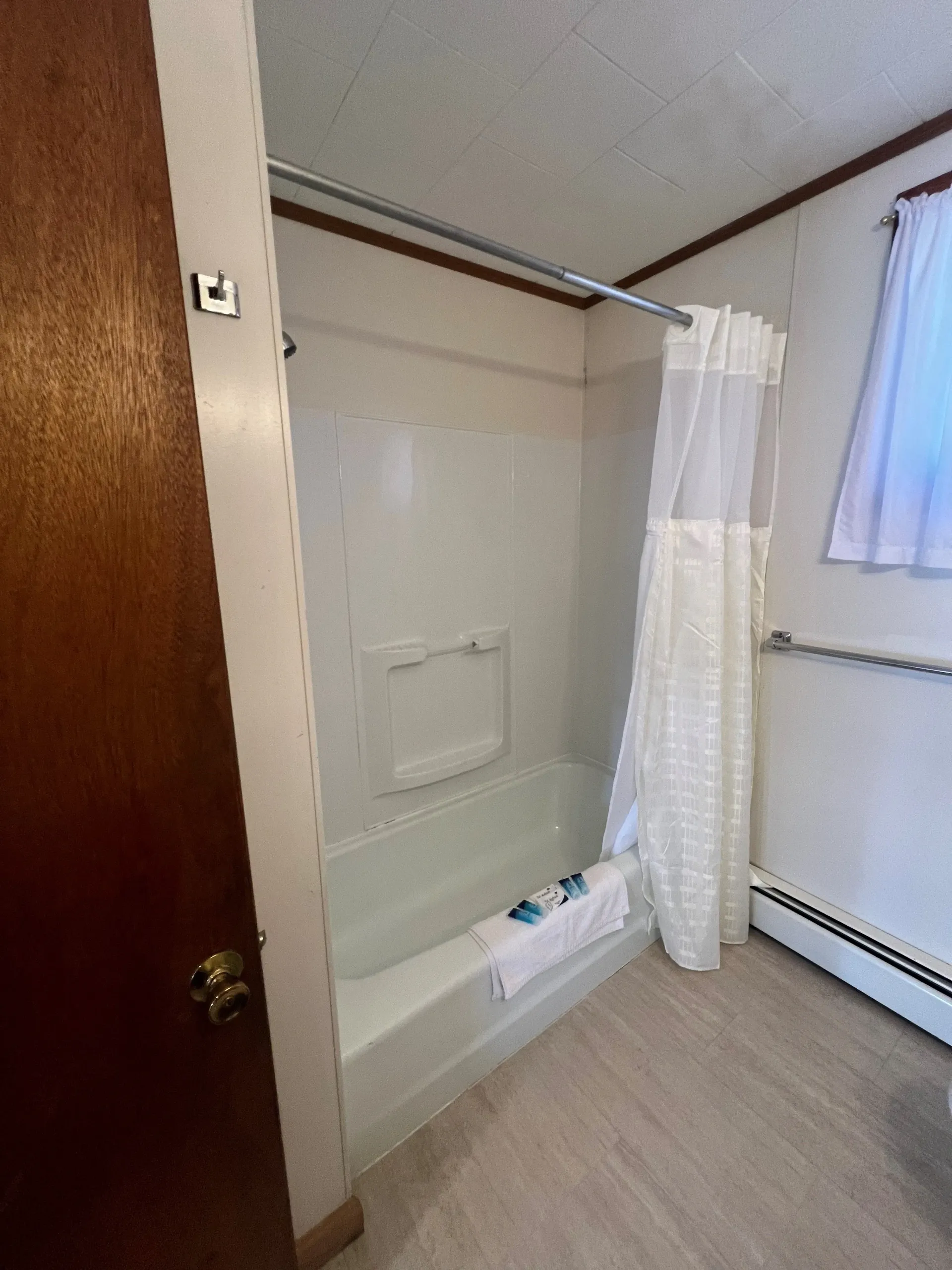 A bathroom with a bathtub and a shower curtain.
