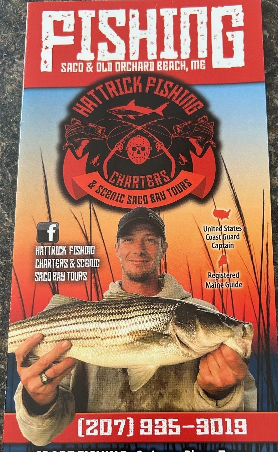 A man is holding a large fish on a fishing poster