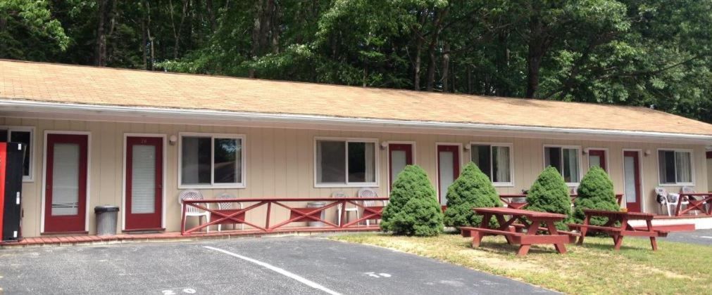A motel with a picnic table in front of it