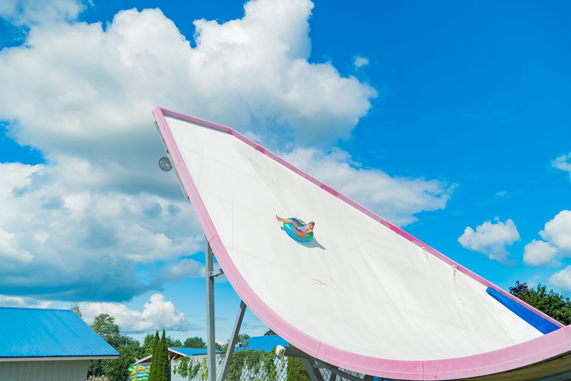 A person is riding down a water slide at a water park.